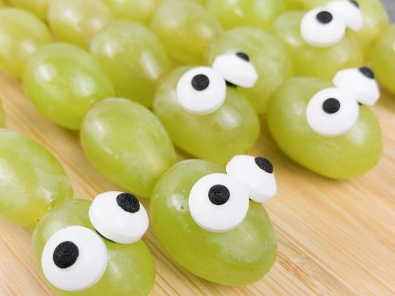 green grapes organized in lines on skewers with faux eyes made out of something edible. and against a pink background for this food entry. caribu mommy mom mother's blog that gives parenting advice for kids, children, toddlers, preschoolers.