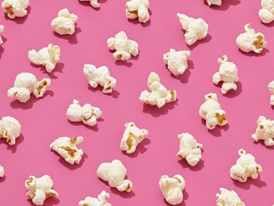 regular popcorn organized in lines and against a pink background for this food entry. caribu mommy mom mother's blog that gives parenting advice for kids, children, toddlers, preschoolers.